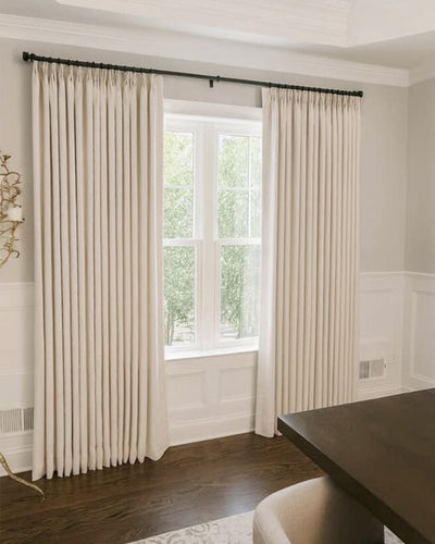 The Zen linen curtains used as decorative side panels in a modern dining room.