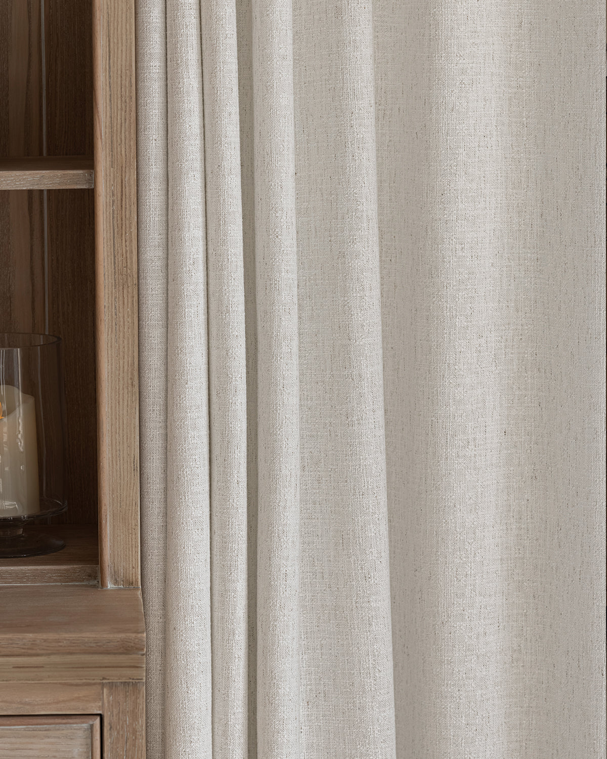 The Alma linen blend drapes providing a neutral textured backdrop in a cozy living space.