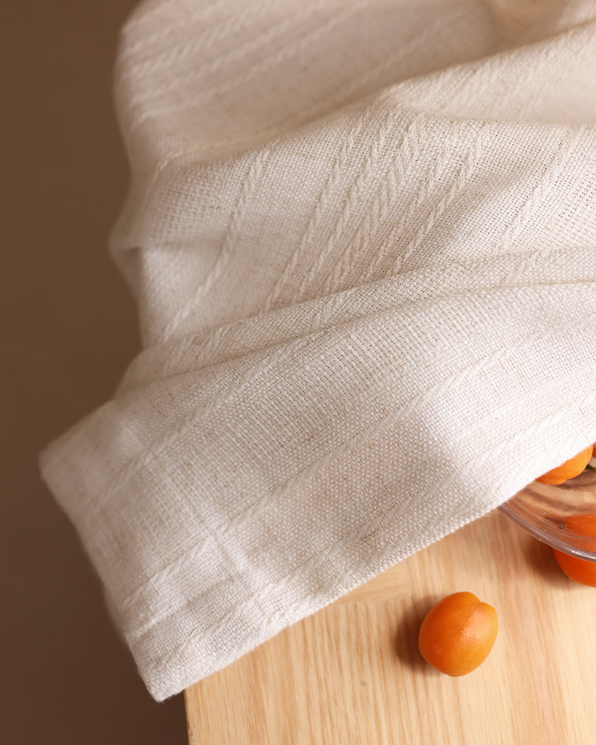 A close-up of the soft pleats and woven striped texture of the Hazel linen curtain.