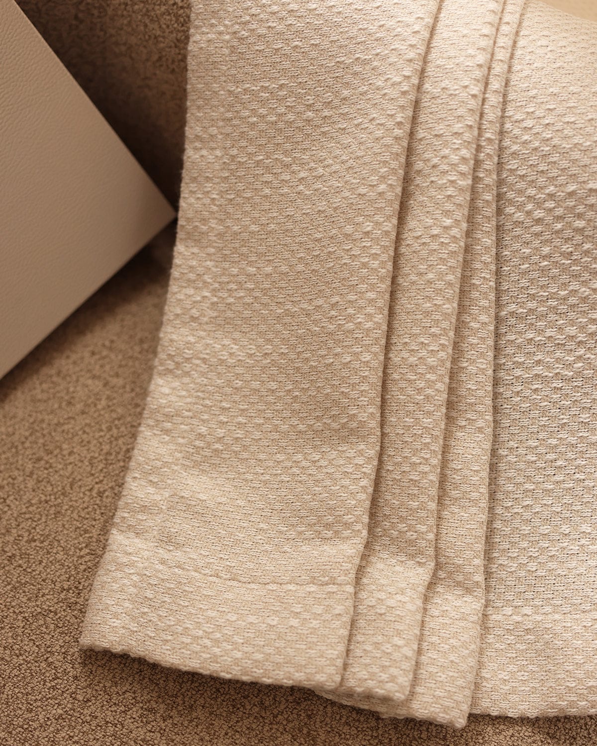 An extreme close-up of the folded milk tea Sophie fabric, showing its small checkered weave.