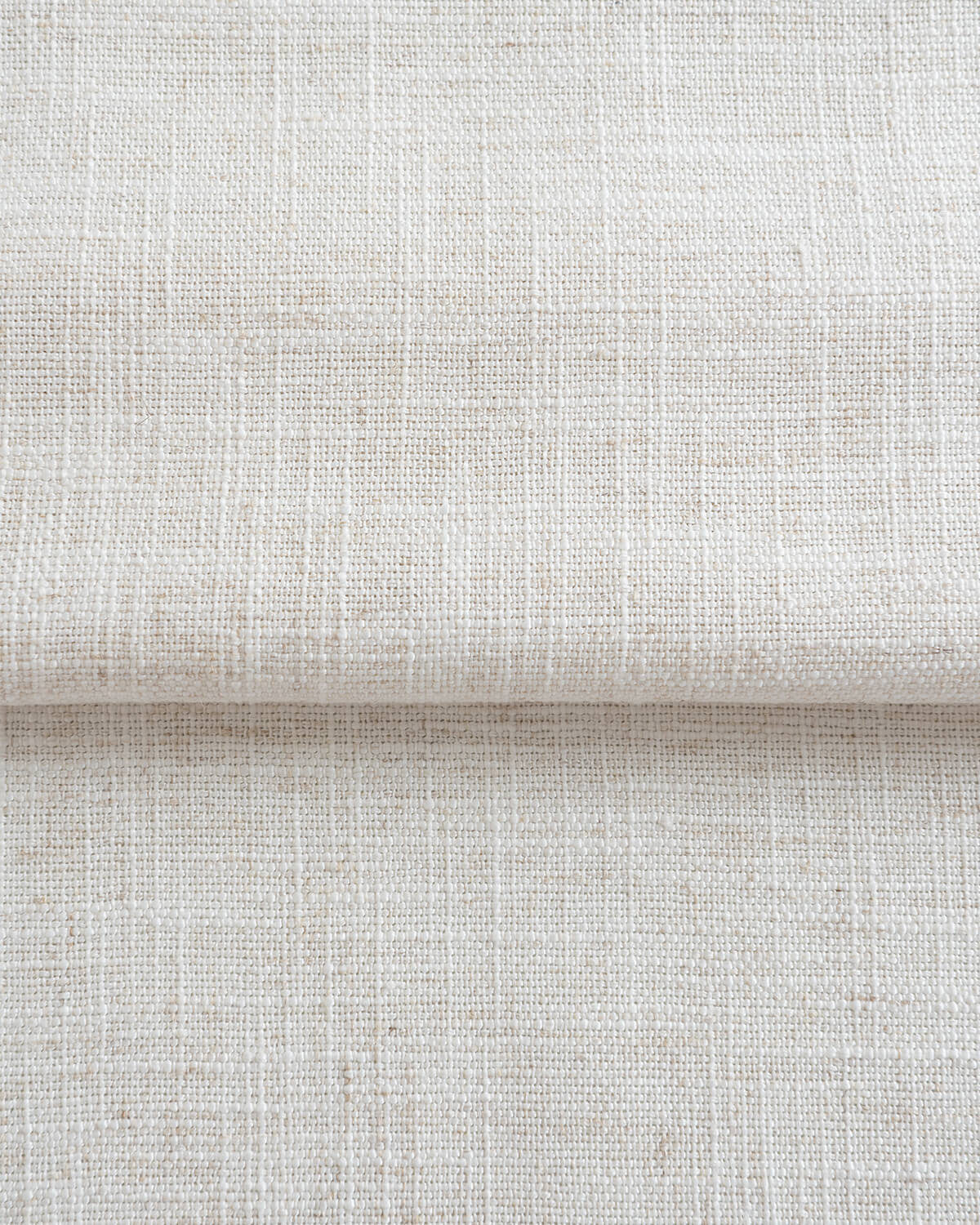 The natural woven texture of the Zen linen blend curtain fabric shown folded.