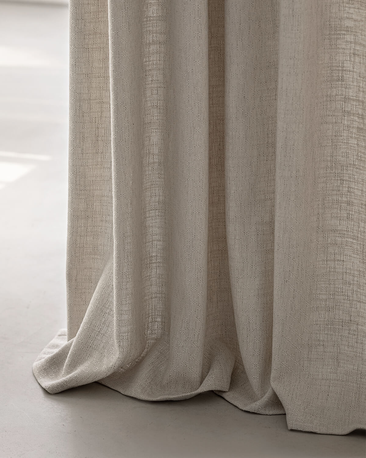 A close-up of the heavyweight Alma linen drape, showing its natural texture and soft folds.