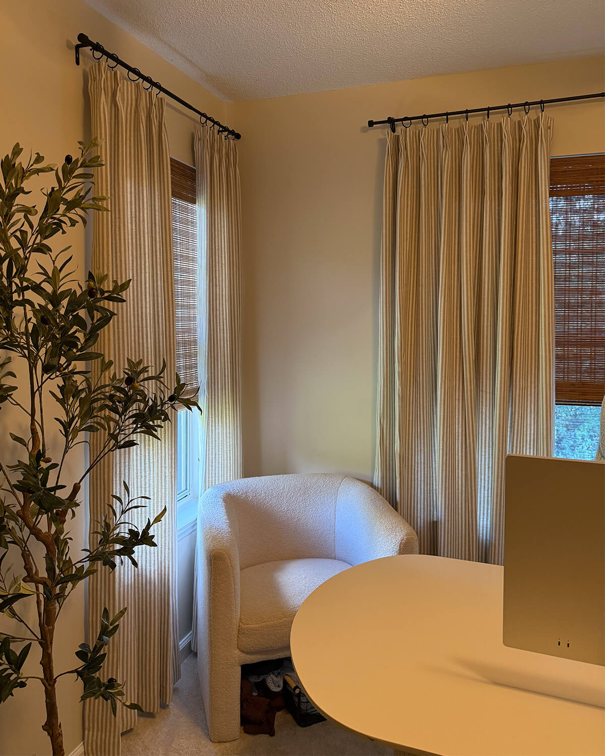 Zaria beige striped drapes styled with bamboo blinds in a cozy home office corner.