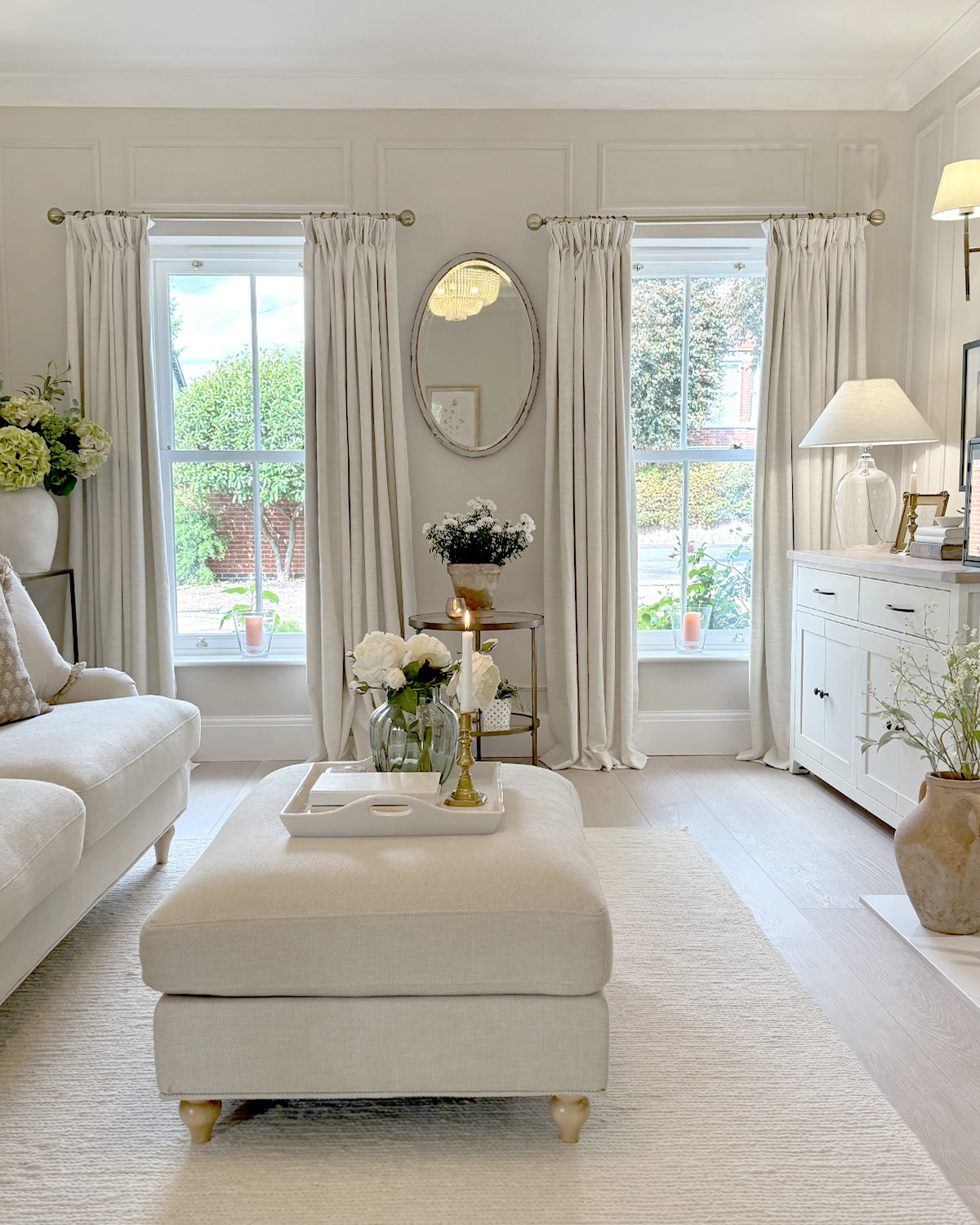 Zen linen blend curtains hanging in a bright and elegant, neutral-toned living room.