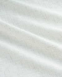 A close-up texture shot of the Luma curtain fabric, revealing the intricate herringbone weave of the linen blend.