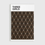 A fabric swatch for the Delphine curtain, showcasing its jacquard weave with a diamond pattern in rich brown and white