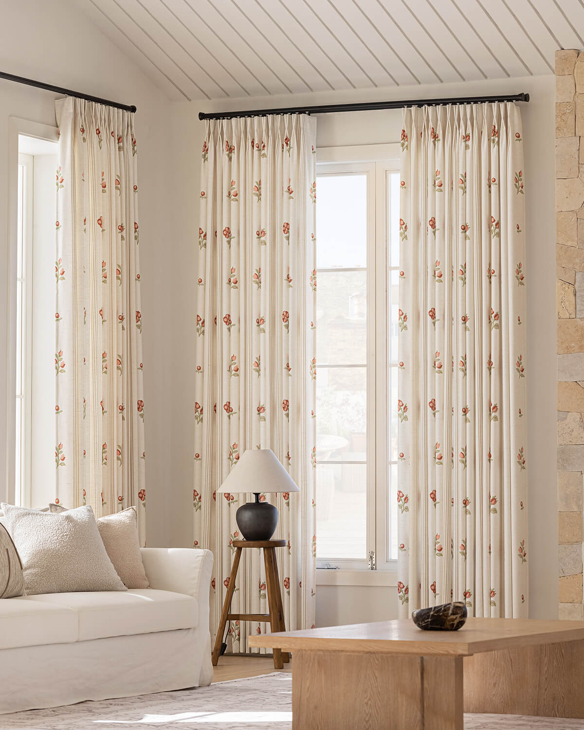 Bella hand-painted camellia pinch pleated floral curtains in a bright living room