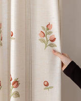 A hand touching the premium 366gsm floral linen curtains for living room