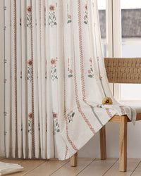 Long curtains with botanical cosmos floral print for a refined bedroom makeover