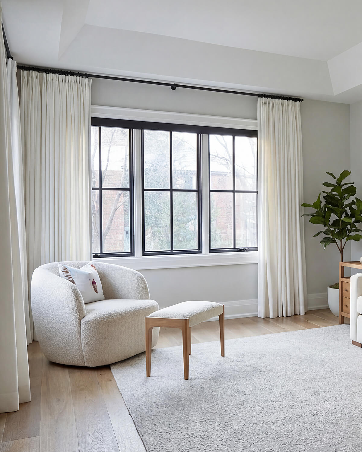 Luma herringbone linen curtains creating a soft, light-filtering backdrop in a neutral-toned living room.