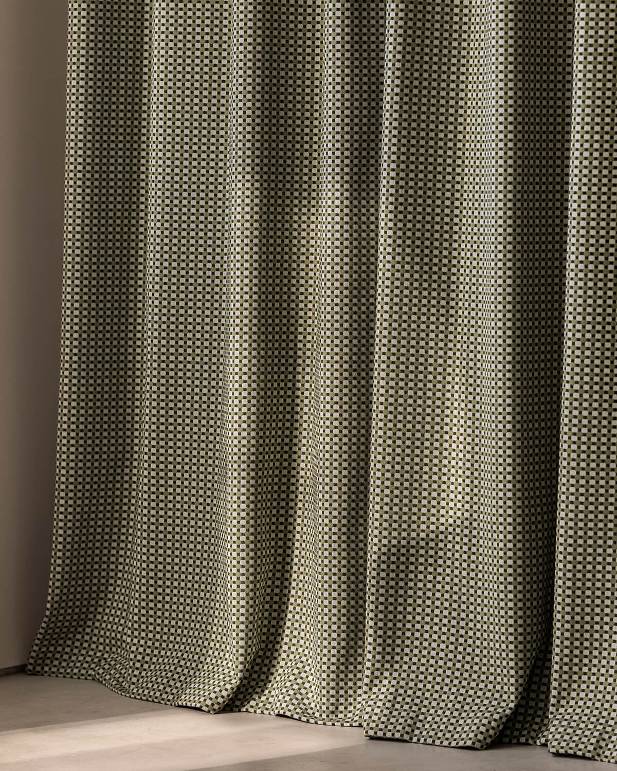 A full view of the heavyweight Frankie plaid curtain panel and its elegant, room-darkening drape.