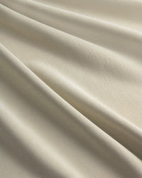 A close-up of the soft, textured fabric of the Chenille blackout curtain in Fuzz beige.