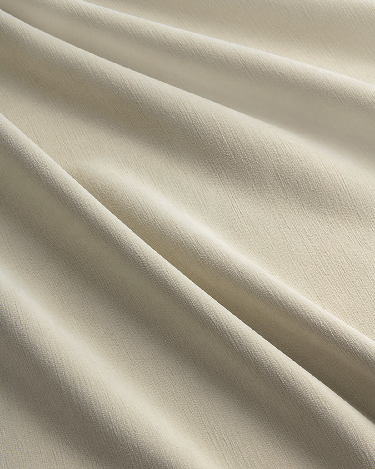 A close-up of the soft, textured fabric of the Chenille blackout curtain in Fuzz beige.