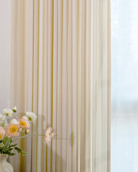 Close-up of beige pinstripe cotton blend curtains showing lightweight texture and 50 percent light blocking.