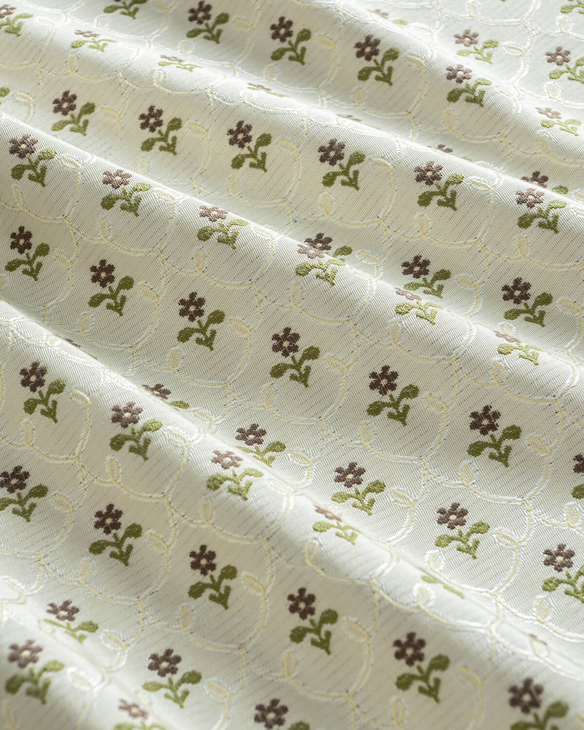 Close-up of the intricate ditsy floral pattern on 350 gsm thick recycled fiber curtains for a sustainable home.