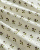 Close-up of the intricate ditsy floral pattern on 350 gsm thick recycled fiber curtains for a sustainable home.
