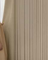A hand pulling back the sheer layer to reveal the thick, Fuzz beige Chenille blackout curtain.