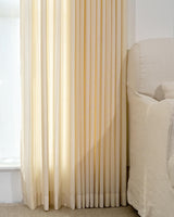Beige striped curtains with well-draped 200gsm fabric, soft pleats and floor-length hem by window.