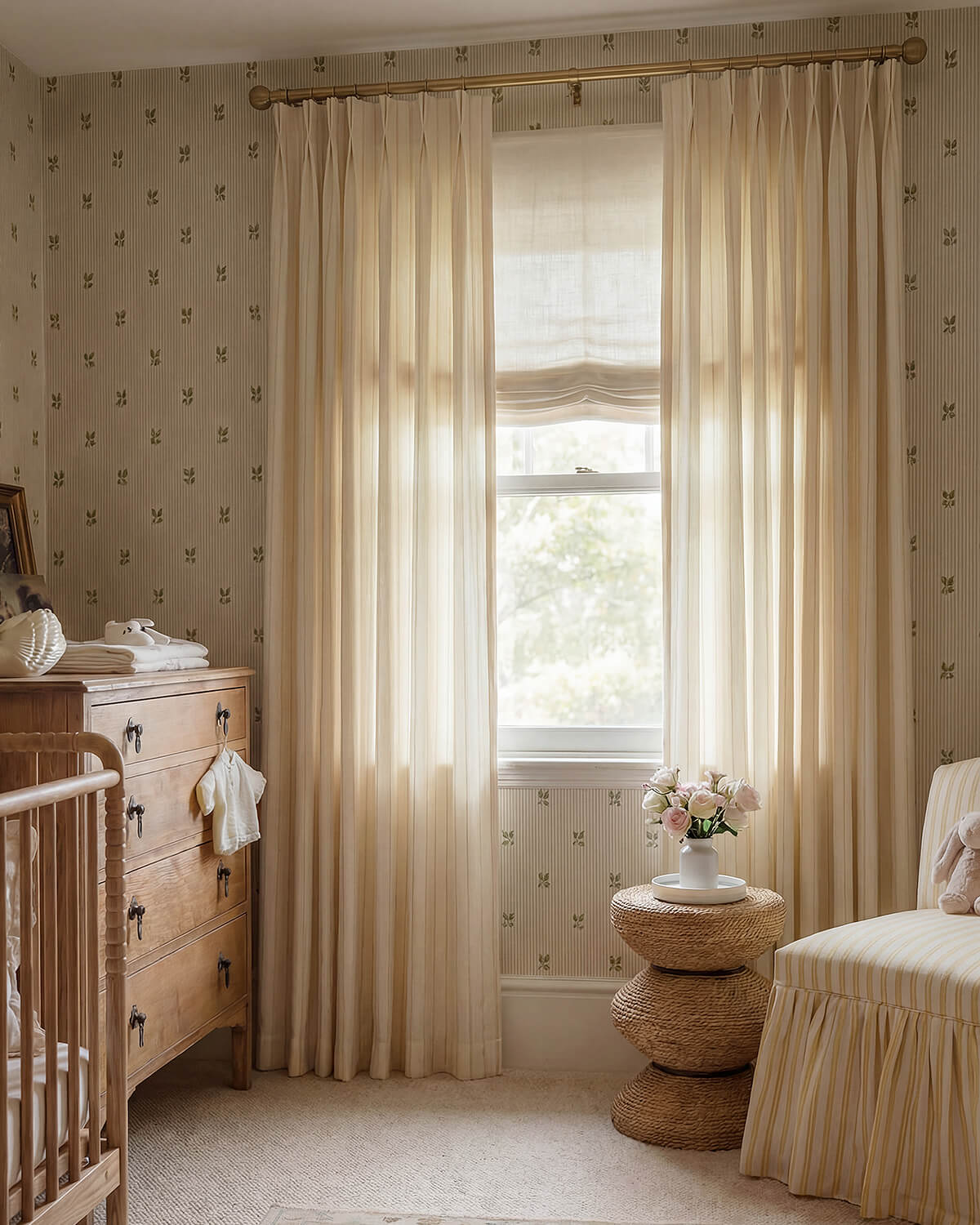 Darcy Striped Cotton Blend Beige Curtains in a nursery with floral wallpaper and a vintage wooden dresser.