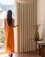 Elegant cream waffle knit curtains with ruffle detailing displayed in a cozy corner with a vintage table and glass vase.