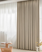 A full view of the heavy Chenille blackout pinch pleated curtain in a warm 'Fuzz' beige tone.