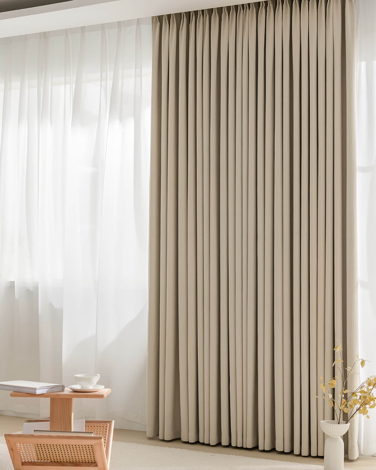 A full view of the heavy Chenille blackout pinch pleated curtain in a warm 'Fuzz' beige tone.