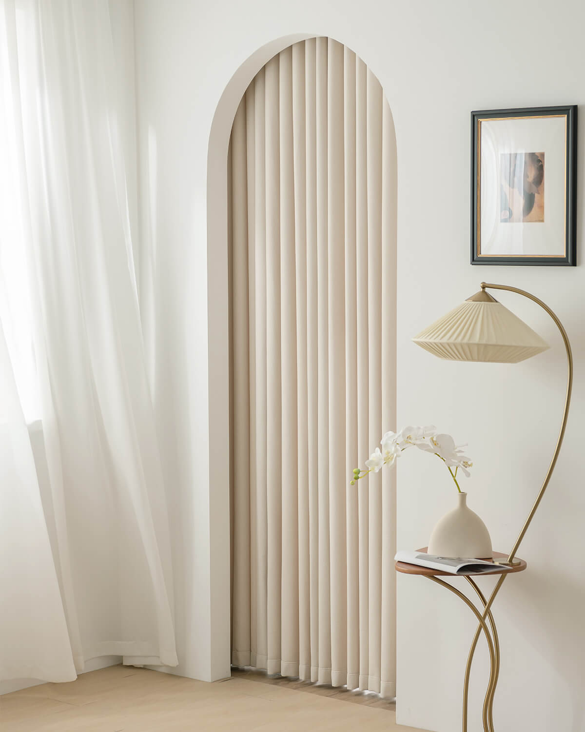 Kely Chenille pinch pleat curtains used to frame an arched doorway in a minimalist interior.