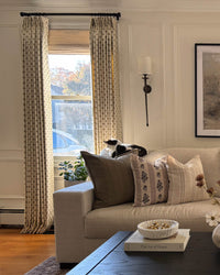 Long curtains with a delicate floral motif styled in a luxury puddle length for traditional drapery trends 2026.