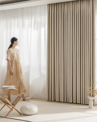 A side view showing the deep, even pleats of the Fuzz beige Chenille blackout curtain.