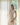 A woman peeking from behind the semi-sheer Liz linen textured curtain panel.