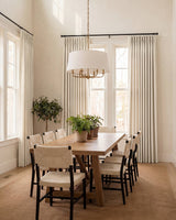 Elegant floor-to-ceiling Sand Chenille curtains styled in a modern dining room featuring a wooden table and black chairs.