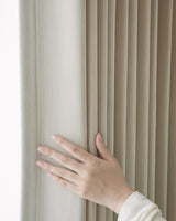 A close-up shot of a hand touching the thick, 536gsm Vivi Chenille fabric to highlight its premium quality and soft feel.