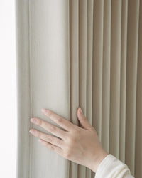 A close-up shot of a hand touching the thick, 536gsm Vivi Chenille fabric to highlight its premium quality and soft feel.