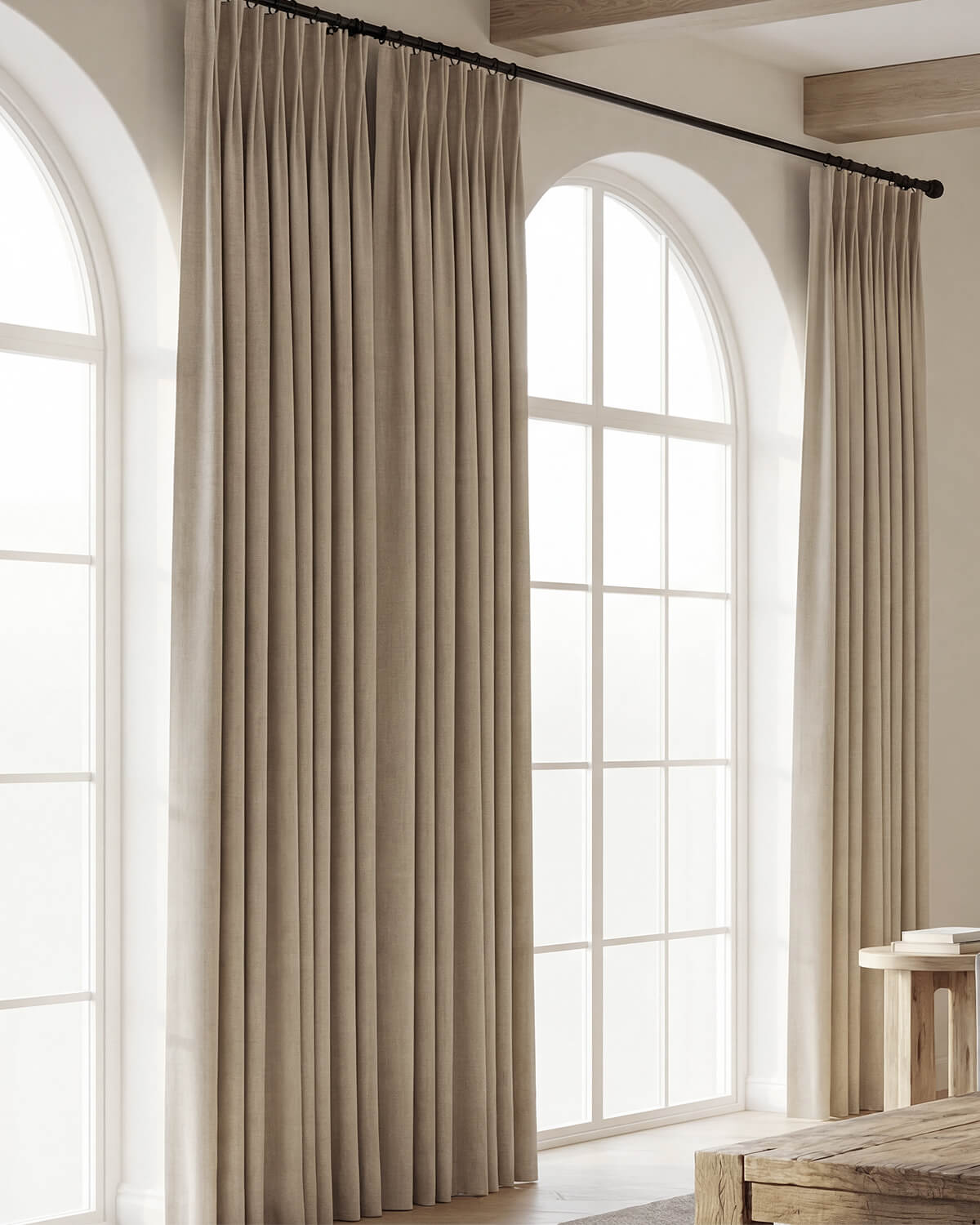 Tailored Vivi Chenille pinch pleat curtains framing tall arched windows in a spacious, modern interior.